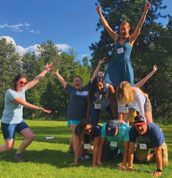 A group of people making a human pyramid.
