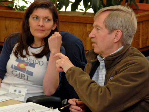 two people, one talking and one listening.