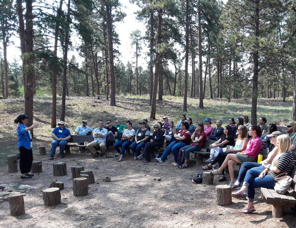 Group of people listening to presenter.